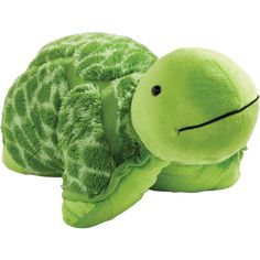 a green stuffed turtle laying on its side