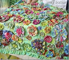 an image of a quilted bed with flowers on it