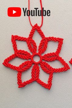 an ornament made out of red thread with the words youtube written on it