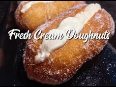 two doughnuts covered in icing sitting on top of a black plate with the words, fresh cream doughnuts