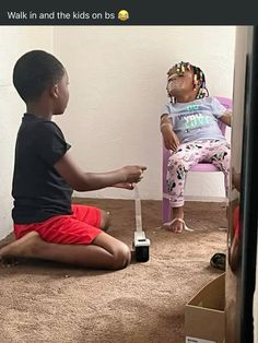 two children sitting on the floor playing with remotes