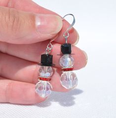 Festive Christmas Snowmen Earrings handmade with Swarovski (highest quality) Crystals.  Great to wear throughout the holiday season, or give as gifts for co-workers, teachers, friends, and family!  8mm and 10mm Clear crystal snowmen with black hat and your choice of red, green, or clear crystal scarves.  Silver-plated ear wire - Overall earring length is 1.5 inches.  Please check out all my other listings for free shipping on combined items totaling $35+   Brenda's All About Beads shop includes Gemstone Pendants, Gemstone Earrings, Swarovski Crystal Earrings, Shell Earrings, Shell Pendants, Paua & Abalone Shell, Venetian Glass Earrings, Dichroic Glass Earrings, Holiday Earrings, and more!  New listings posted daily! Snowmen Earrings, Christmas Earrings Handmade, Gifts For Co Workers, Christmas Jewelry Diy, Christmas Jewellery, Christmas Snowmen, Dichroic Glass Earrings, Holiday Earrings, Gemstone Pendants