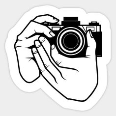 a person holding a camera in their hand