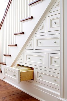 an image of a staircase with drawers under the banister and underneath the stair railing