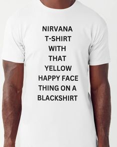 a man wearing a white t - shirt with the words nirvana written in black on it