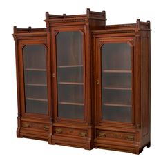 an old wooden bookcase with glass doors