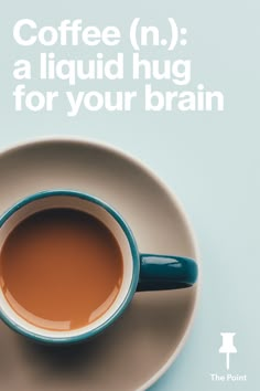 a cup of coffee sitting on top of a saucer with the words coffee n'a liquid hug for your brain