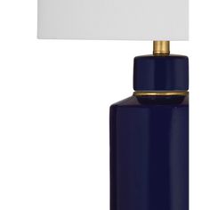 a dark blue table lamp with a white shade on the top and gold trim around the base