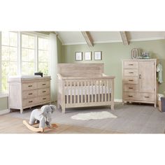 a baby's room with a crib, dresser and rocking horse in it