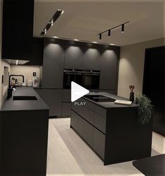 an image of a kitchen setting with black cabinets