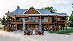 an image of a house that is in the middle of some grass with chairs around it