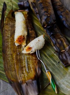 some food is laying out on a banana leaf