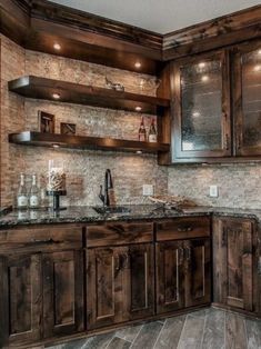 a large kitchen with wooden cabinets and marble counter tops, along with wood flooring