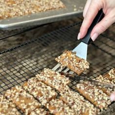 a person is cutting into some food on a rack