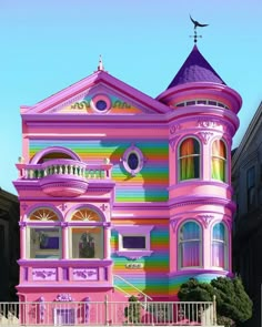 a large pink house painted in rainbow colors