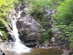 there is a small waterfall coming out of the rocks