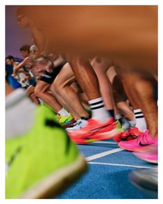 many people are running on a track with their feet in the air and wearing socks