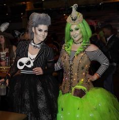 two women dressed in costumes standing next to each other