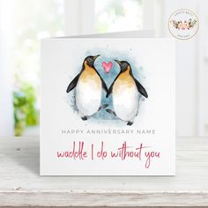 an anniversary card with two penguins on it