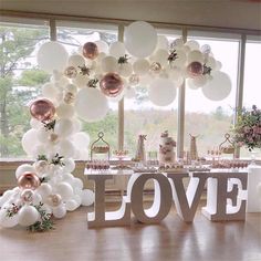 the table is set up with balloons and decorations