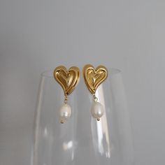 Fall in love with our Pearl Drop Heart Earrings! These flirty earrings feature a heart design with a playful pearl drop, making them perfect for any girly and feminine look.  -stainless steel, gold plated Pearl Drop Earrings, Ear Jewelry, Heart Jewelry, Pearl Drop, Heart Earrings, Heart Design, A Heart, Pearl Jewelry, Bridesmaid Gifts