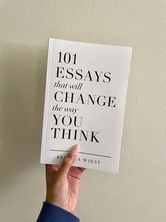 someone holding up a book with the title 101 ways that will change the way you think