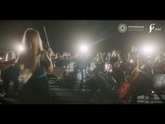 a group of people standing around each other in front of microphones with lights on them