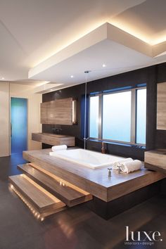 a bathroom with a large bathtub and wooden steps