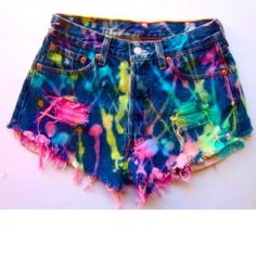 a pair of shorts with colorful paint splattered on the side and frayed at the bottom