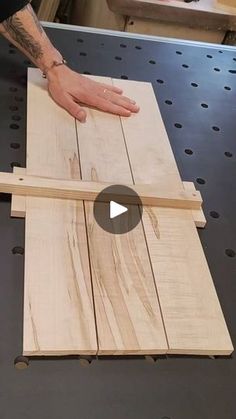 a person is making wooden planks on a table