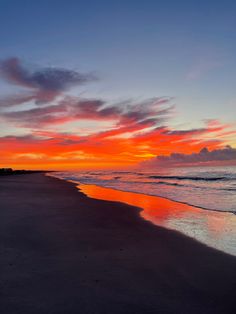 the sun is setting at the beach with waves coming in