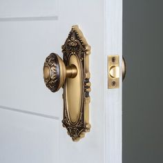 an ornate door handle on a white door