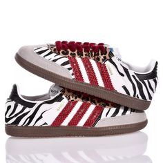 Adidas Samba Exotic is the custom sneaker youve been waiting for! Covered in soft zebra animal print, with leopard print eyelets and red eco-python stripes, these sneakers will elevate every look! The look of this sneaker is completed with red velvet laces. Red Sambas, Leopard Adidas, Leopard Print Adidas, Bday Wishlist, Ysl Sandals, Zebra Animal, Versace Sweatshirt, Expensive Handbags, Jimmy Choo Bag