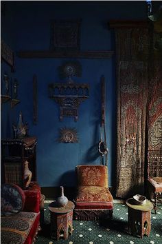 an ornately decorated living room with blue walls and green carpeted flooring is pictured in this image