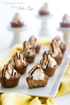 mini desserts with ice cream and chocolate drizzled on top are lined up