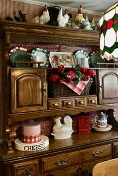 a hutch with christmas decorations and dishes on it's shelves, including an old fashioned china cabinet