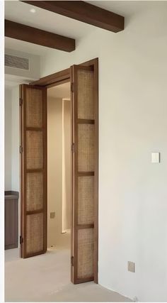 an open door leading into a room with white walls and wood trimming on the doors