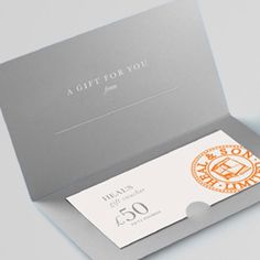 a gift for you card in a box with an orange and white logo on the front