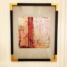 an abstract painting hanging on the wall