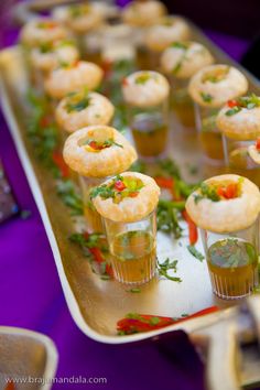 small appetizers are lined up on a tray