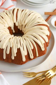 a bundt cake with white icing on a plate