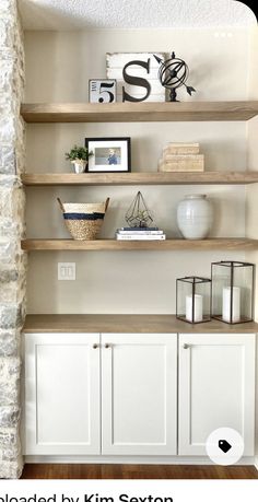 the shelves in this living room are made out of wood and have white paint on them