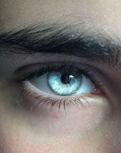 a close up of a person's blue eye