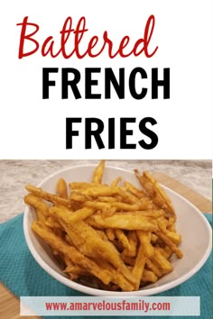 a white bowl filled with french fries on top of a table