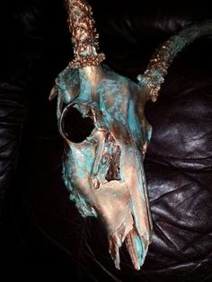 an animal skull is sitting on a leather couch