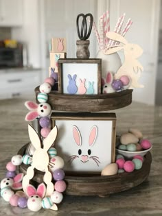 an assortment of easter decorations on top of a wooden stand with eggs and bunnies