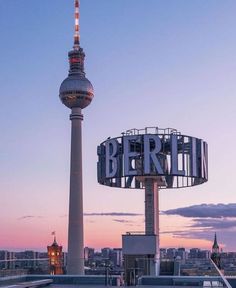 the berlin tv tower is lit up at dusk