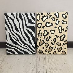 two animal print canvases sitting on top of a white wooden floor next to each other