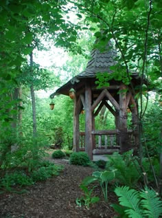 a gazebo in the middle of a wooded area