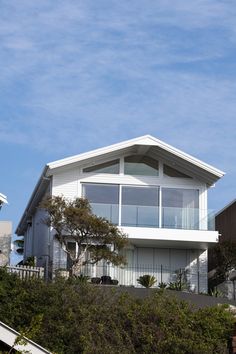 a large white house sitting on top of a hill